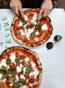 Person Slicing Pizza